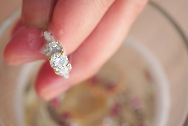 Jeweller hand cleaning vintage jewelry diamond ring closeup