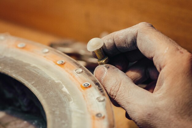 Jeweller polishing a stone blue cubic zirconia