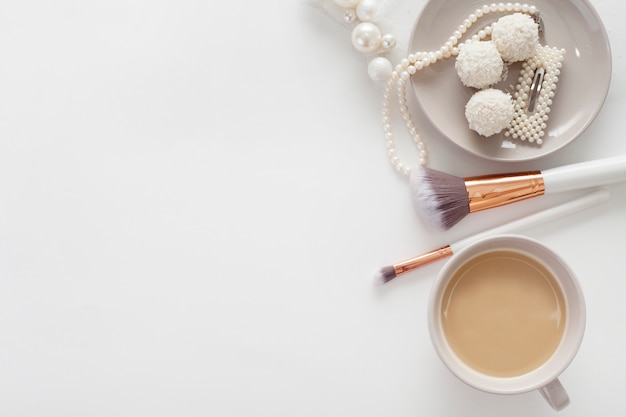 Jewelry for the bride, sweets and coffee, on a white background. Concept weddings, preparation and morning of the bride.