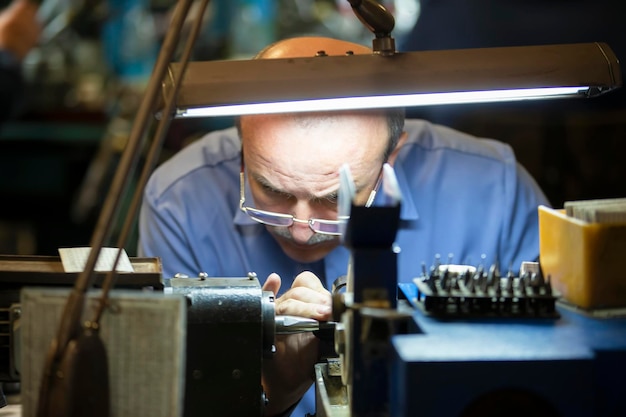 Jewelry industry Worker engraves diamonds