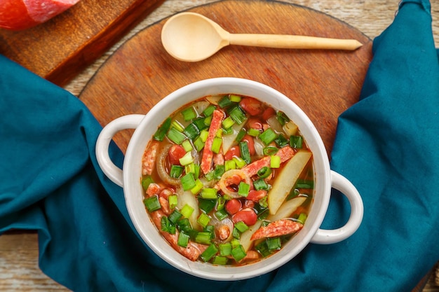 Jewish cuisine bean soup cholit on a blue napkin top view