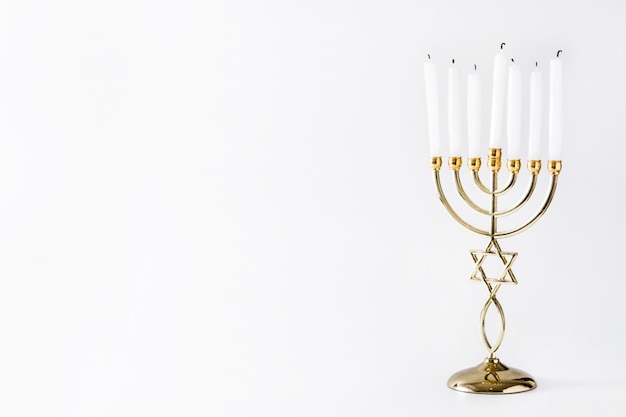 Jewish Hanukkah menorah on white surface