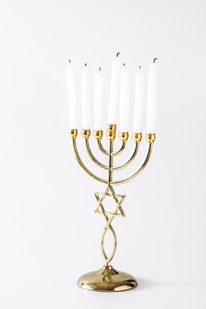 Jewish Hanukkah menorah on white surface