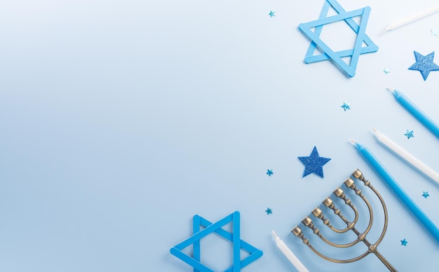 Jewish holiday Hanukkah concept Top view of sweet donuts menorah and candles on blue background