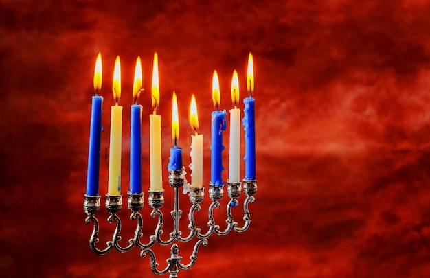 Jewish holiday Hanukkah creative background with menorah. View from above with focus on menorah.