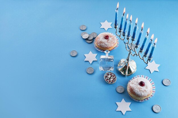 Photo jewish holiday hanukkah with menorah traditional candelabra donut and dreidel spinning top