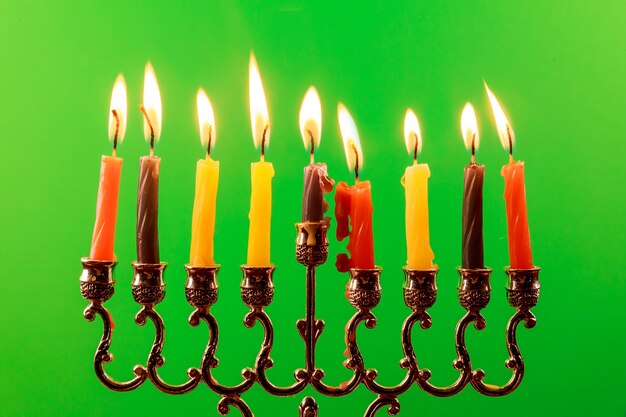 Jewish holiday Hanukkah with menorah traditional and wooden dreidels spinning top . glitter overlay