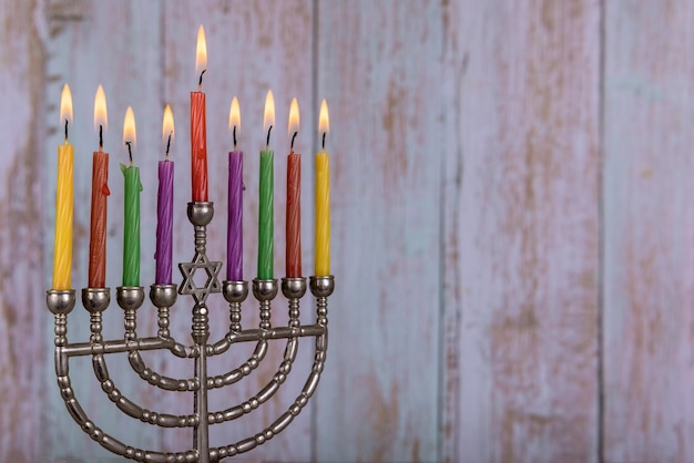 Jewish holiday menorah with burning candles for Hanukkah.