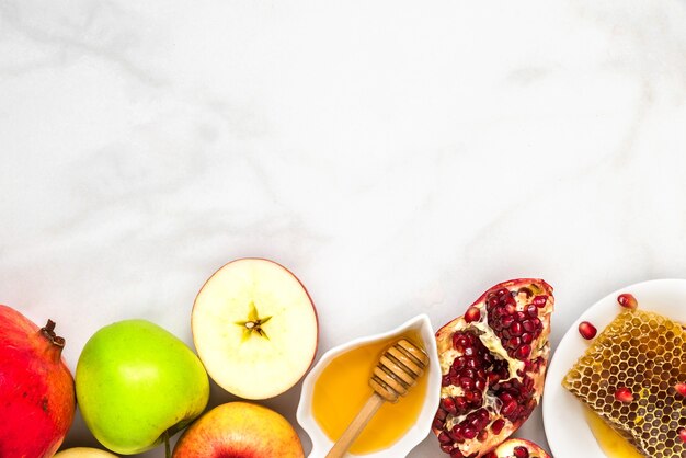 Jewish holiday Rosh Hashana background with honey, pomegranate and apples