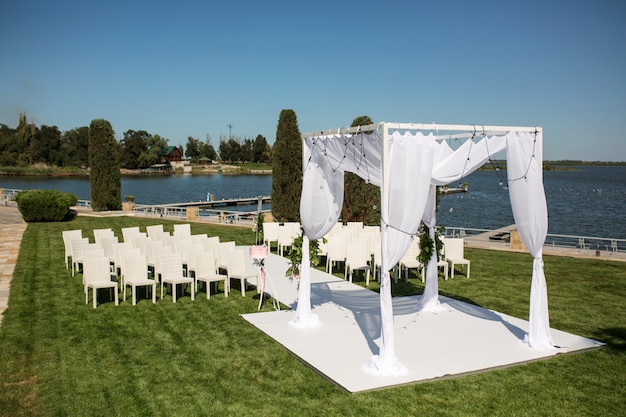 Jewish Hupa  on romantic wedding ceremony , wedding outdoor on the lawn water view