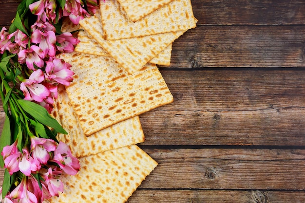 Jewish matzah bread on wooden rustic background. Passover holiday concept