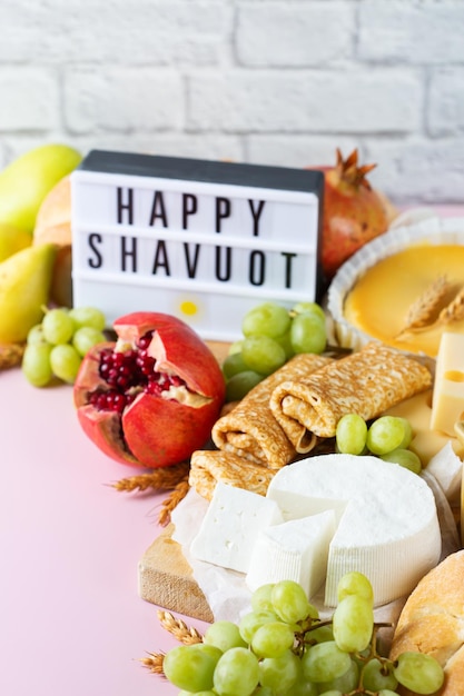 Jewish religious holiday shavuot with dairy products cheesecake pancakes fruits