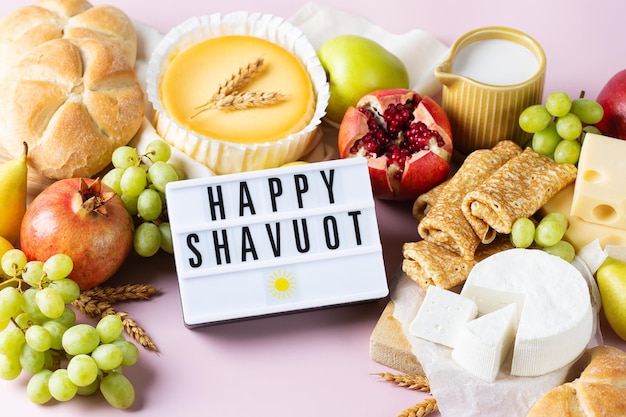 Jewish religious holiday shavuot with dairy products cheesecake pancakes fruits