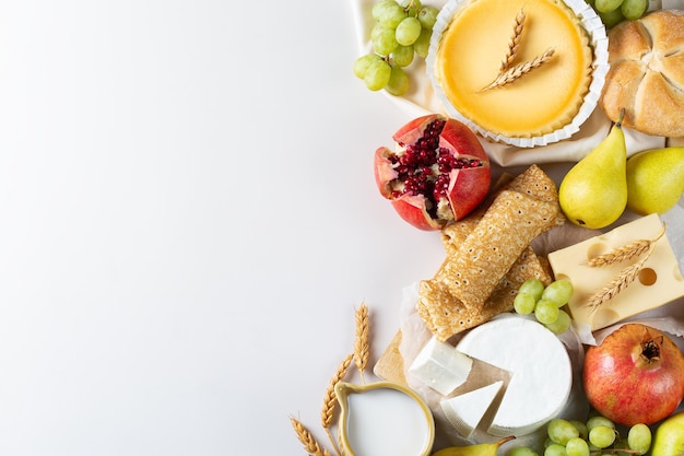 Jewish religious holiday shavuot with dairy products cheesecake pancakes fruits