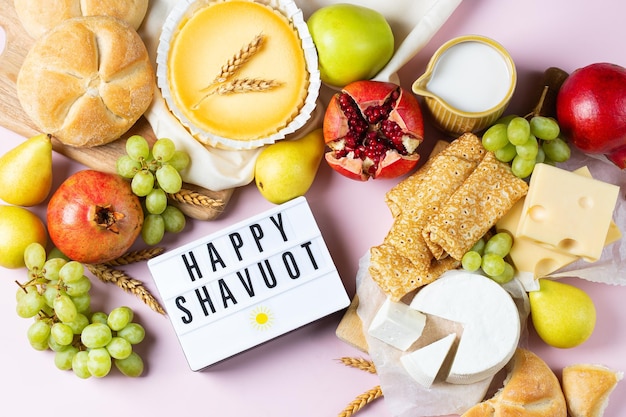 Jewish religious holiday shavuot with dairy products cheesecake pancakes fruits