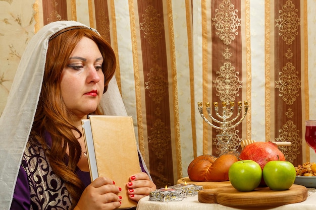 A Jewish woman in a veil falling from her hair after prayer is applied with her forehead to the siddur