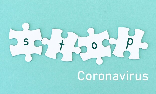 Jigsaw puzzle pieces word stop coronavirus