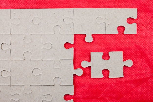 Jigsaw on red background.