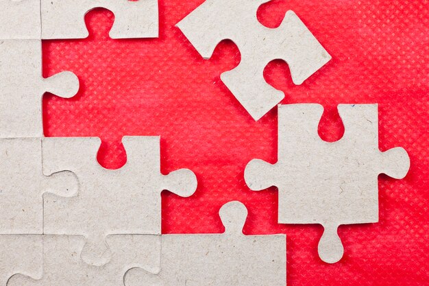 Jigsaw on red background.