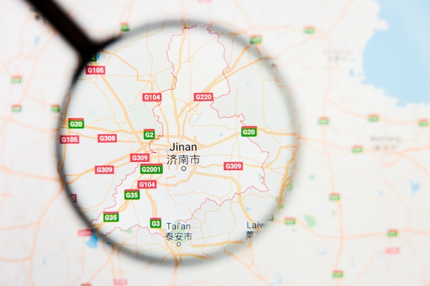 Jinan, China city visualization illustrative concept on display screen through magnifying glass