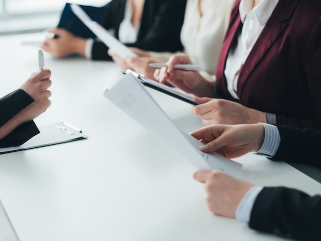 Job interview. Corporate recruitment. HR team examining applicant CV.