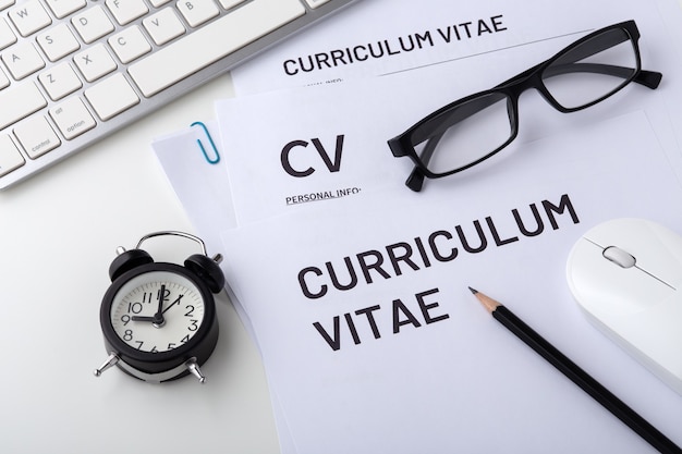 Photo job interview with cv, clock on white desk