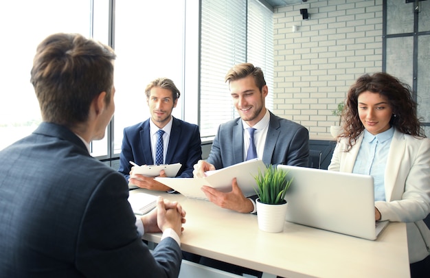 Photo job interview with the employer, businessman listen to candidate answers