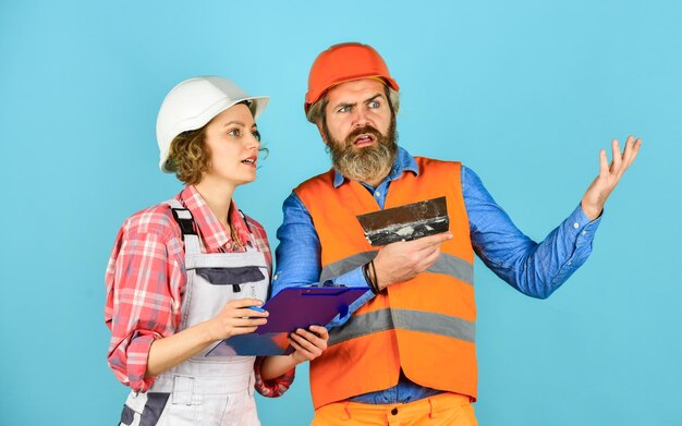 Job and occupation confident electrical and technician engineers couple working together on building blueprint work at construction site or factory Civil engineering industrial business partner