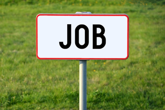 Job white sign on a grass