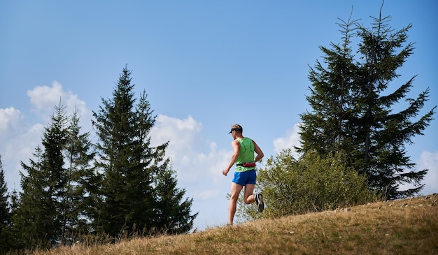 Jogging uphill in the nature at summer