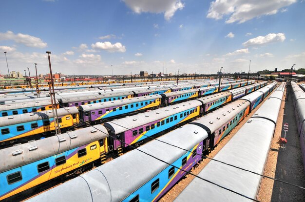 Photo johannesburg south africa march 26 2012 the braamfontein railway yards with their colorful cars under the nelson mandela bridge the yards lie between newtown and braamfontein