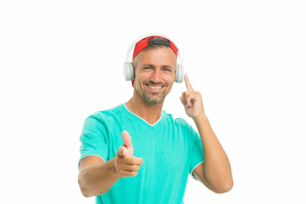 Join along Happy man pointing straight isolated on white Handsome guy listen to music pointing gesture Index finger pointing Pointing for advertising Promotion and advertisement