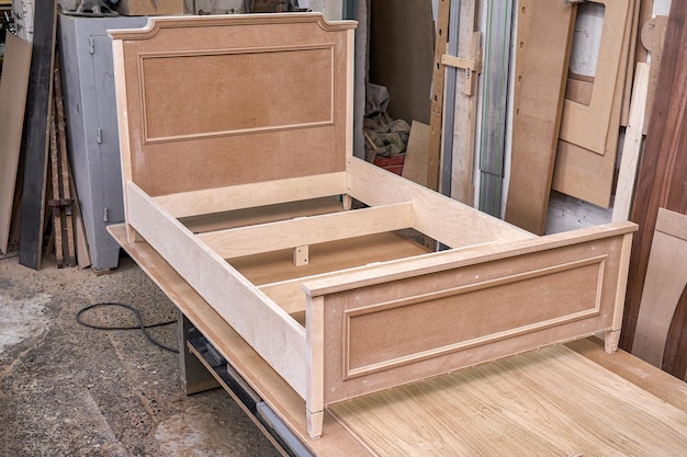 Joinery Professionally made bed of plywood and MDF in process of production in workshop