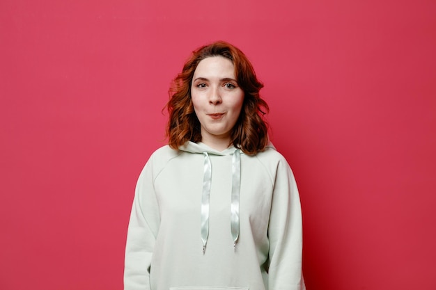 Jokin young beautiful girl in white sweater isolated on pink background