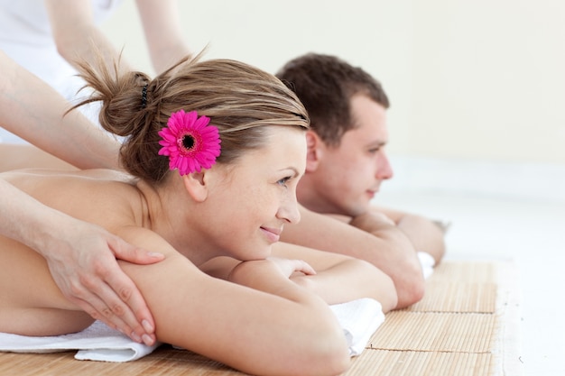 Jolly young couple receiving a back massage