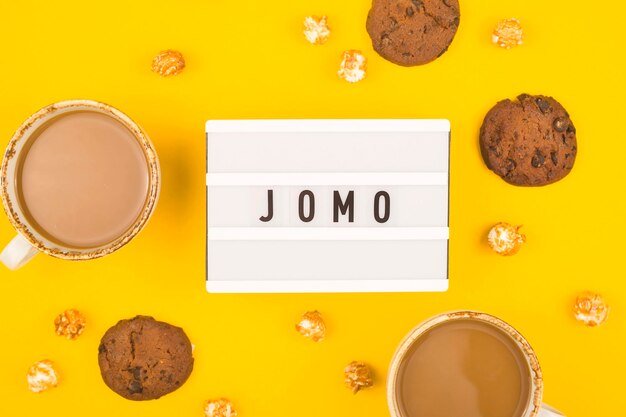 Jomo concept layout with cocoa and biscuits