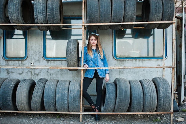 Jong hipstermeisje in jeansjasje en hoofddoek bij bandmontagezone