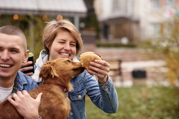 Jong koppel met hond met fast-food lunch