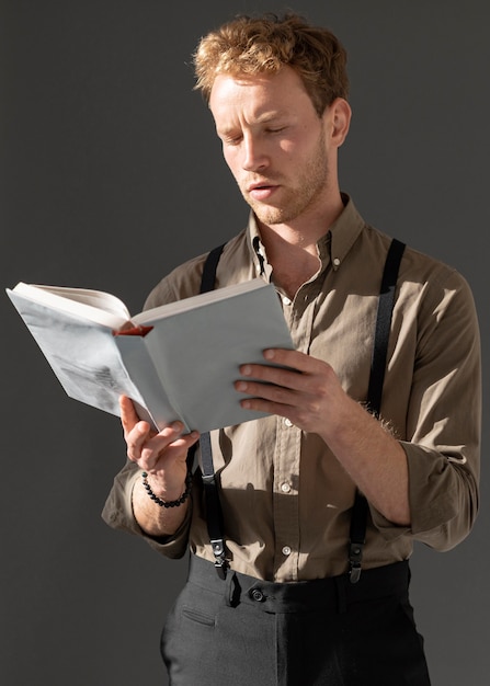 Foto jong mannelijk model dat een boek leest