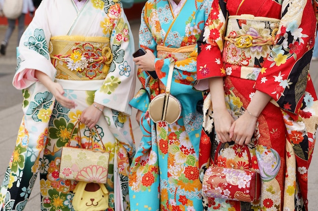 Jong meisje dat Japanse kimono draagt en voor de Sensoji-tempel in Tokio staat. Japan Kimono is een Japans traditioneel kledingstuk. Het woord kimono betekent eigenlijk iets om te dragen
