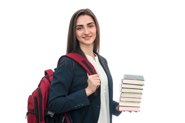 Jong meisje met boeken en tas op wit wordt geïsoleerd