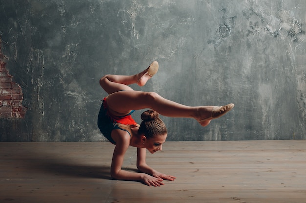 Jong meisje professionele turnster vrouw dans ritmische gymnastiek in de studio.