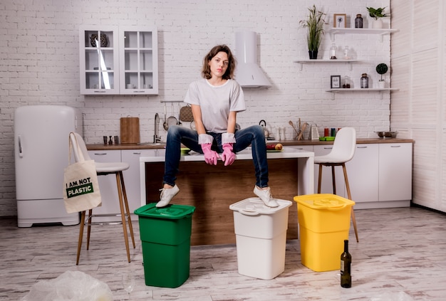 Jong meisjes sorterend huisvuil bij de keuken. Concept van recycling. Zero waste