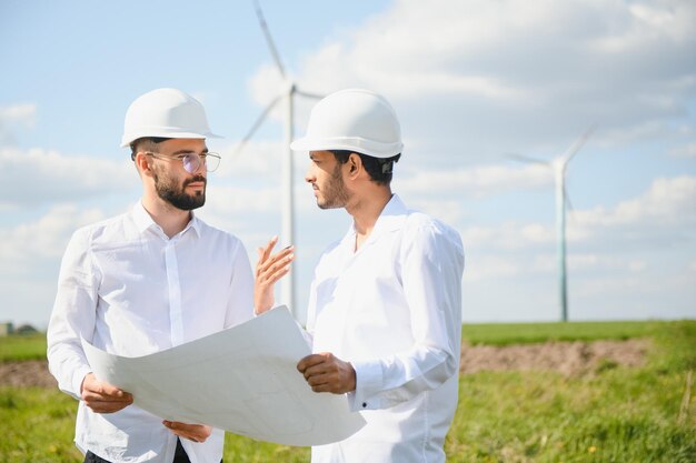 Jong onderhoudsingenieur team dat werkt in een windturbinepark