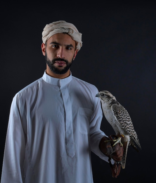 Jonge Arabische prins die een roofvogel vasthoudt.