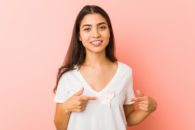 Jonge arabische vrouw met een roze strik. concept van strijd tegen kanker.