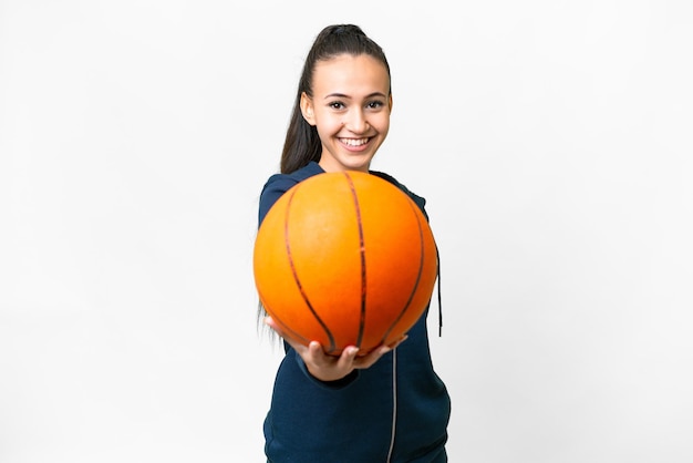 Jonge Arabische vrouw over geïsoleerde witte achtergrond die basketbal speelt