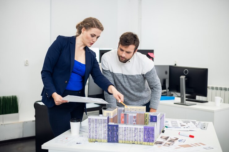 Jonge architectenbureau medewerkers bespreken het bouwmodel