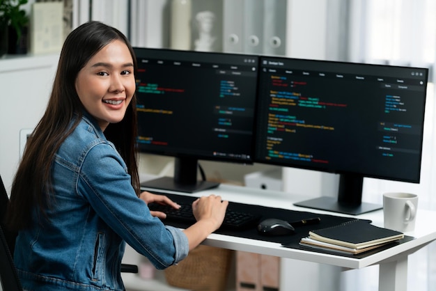 Jonge Aziatische ontwikkelaar die naar de camera kijkt om te presenteren op pc stratagem