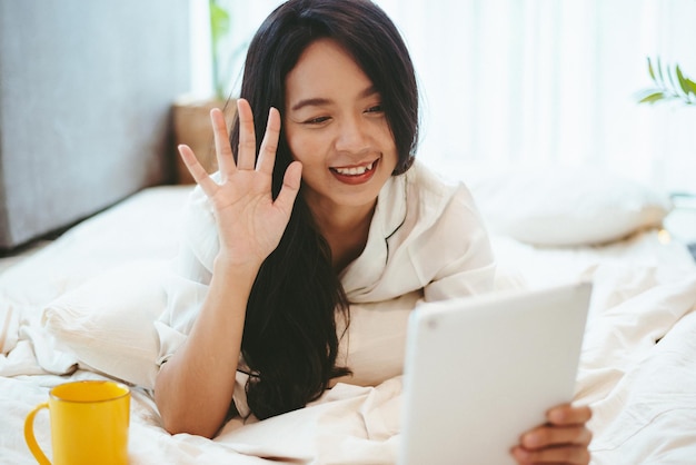 Jonge Aziatische vrouw die laptopcomputer gebruikt om online te werken vrouwelijke freelance werkt vanuit huis met behulp van internet cyberspace-communicatietechnologie voor zakenvrouwen